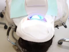 LEDライトを照射してもらっている女性